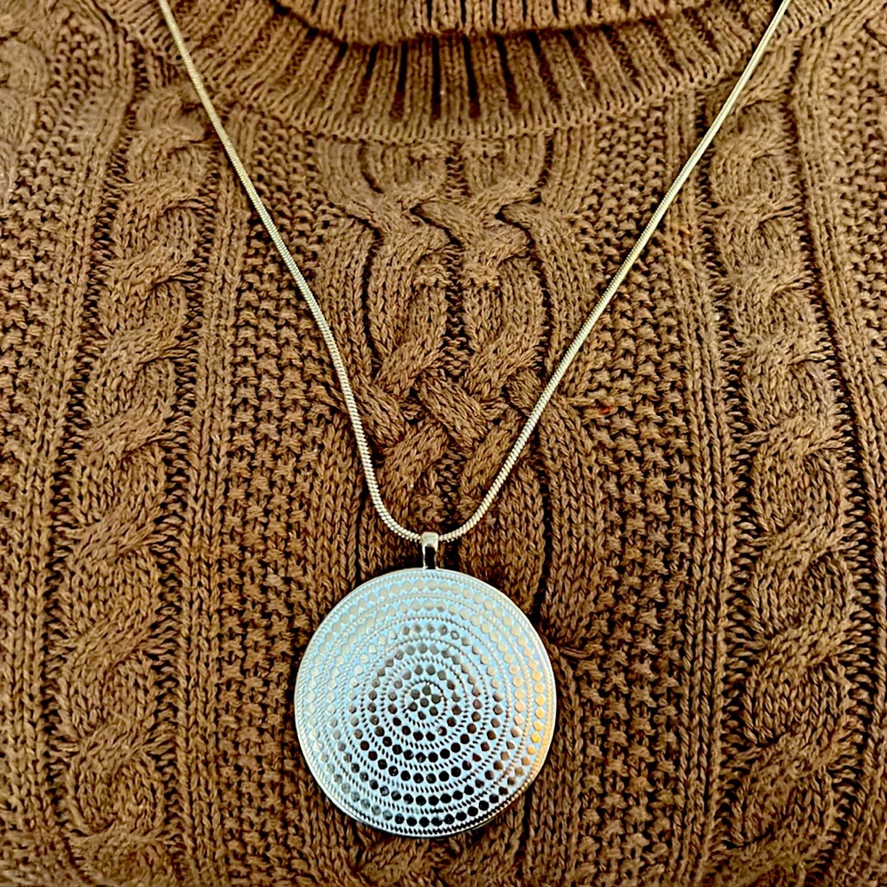 Gold medallion pendant necklace.